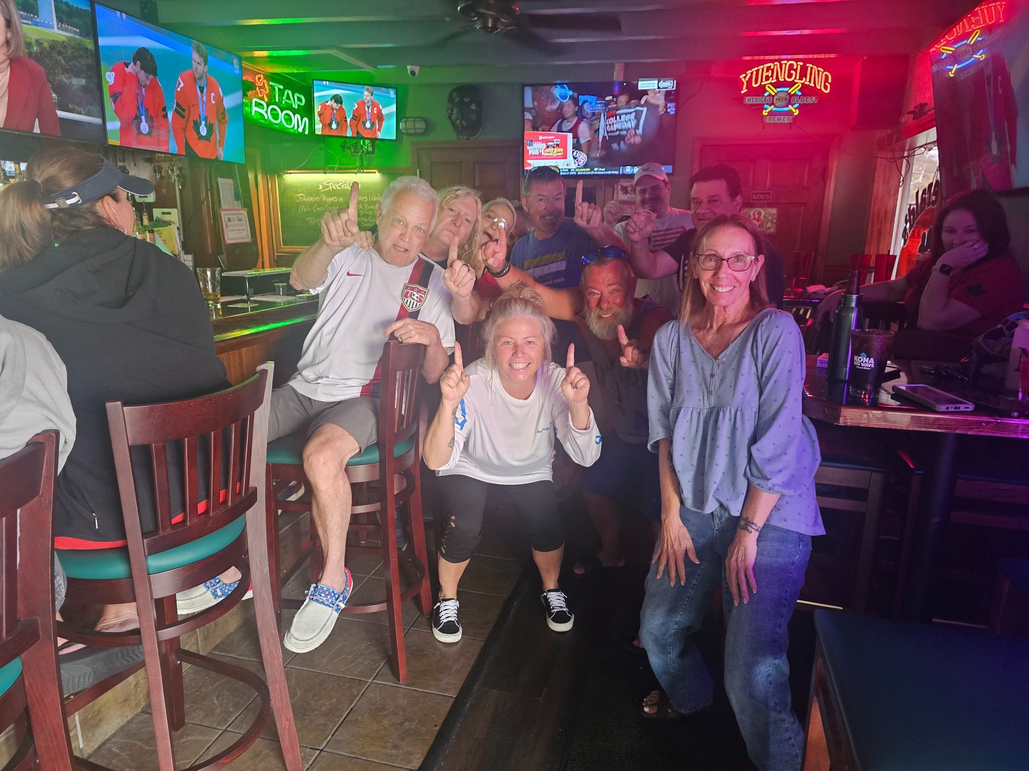 Sports fans watching the game on the HDTVs at the bar