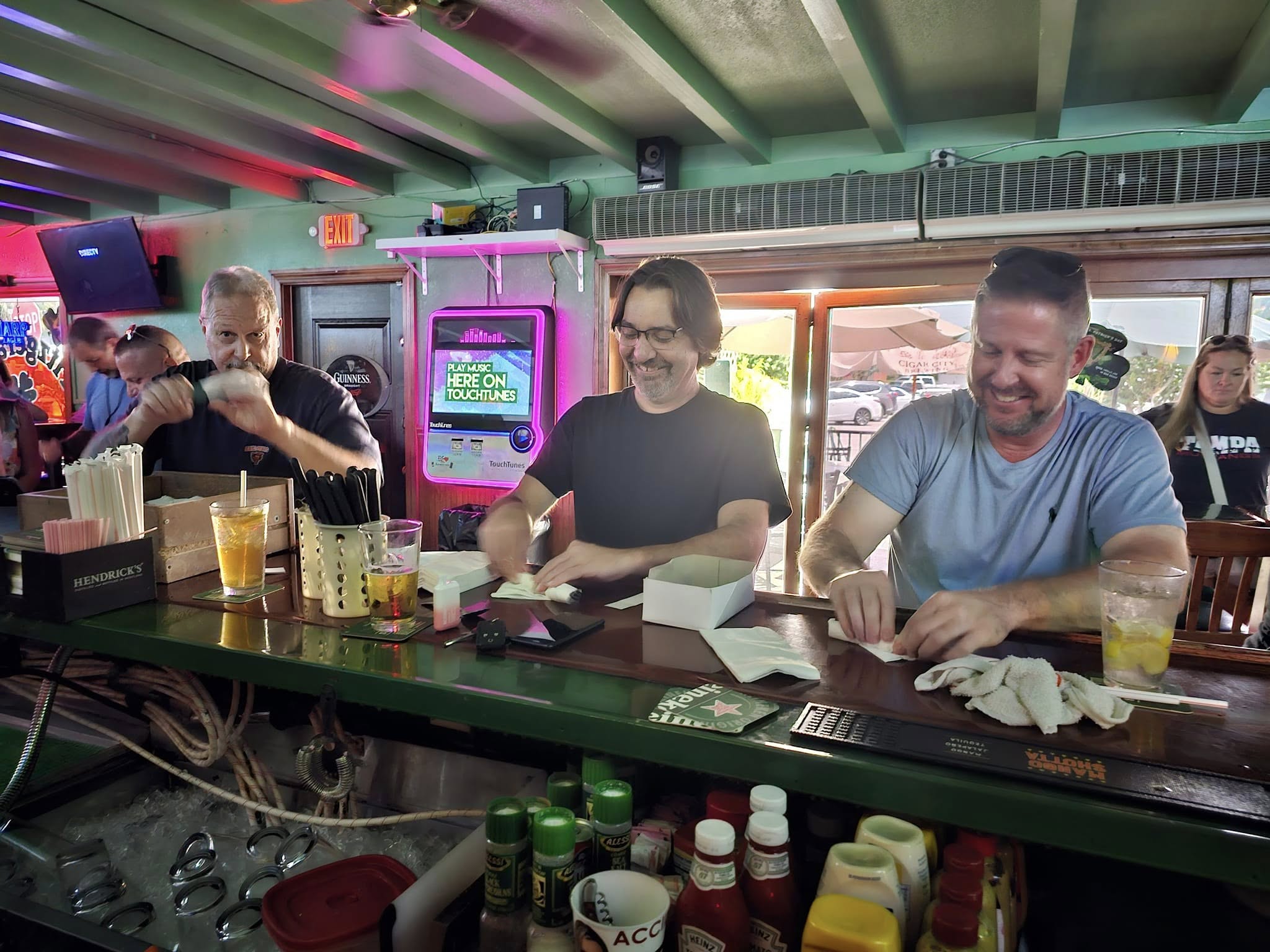 Regulars gathered together enjoying drinks at the tavern
