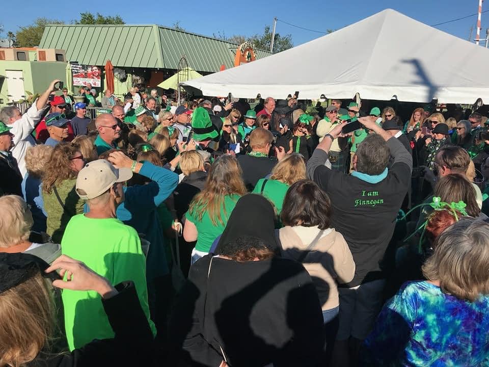 A large St. Patrick's Day crowd celebrating outside at Fitzgerald's Irish Tavern